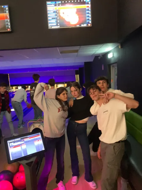 Serata al bowling: ragazzi in posa davanti alle piste
